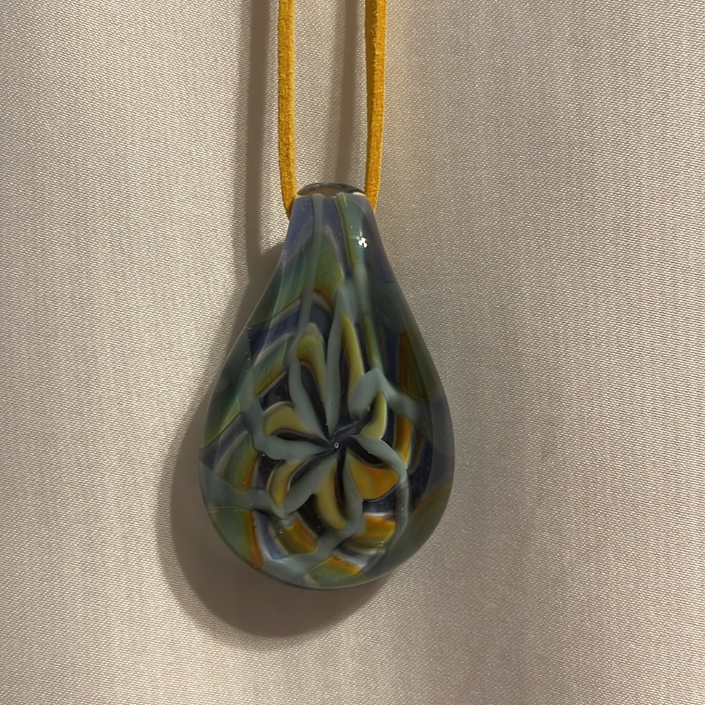 Handmade blown glass pendent—height—2 inches, width(widest part)- 1 1/4 inches